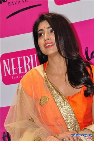 Shriya Saran Stills at label bazaar curtain Raiser Event in Orange Dress  