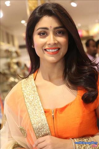 Shriya Saran Stills at label bazaar curtain Raiser Event in Orange Dress  